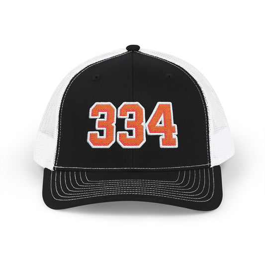 Black and white cap with orange number 334 on a white background